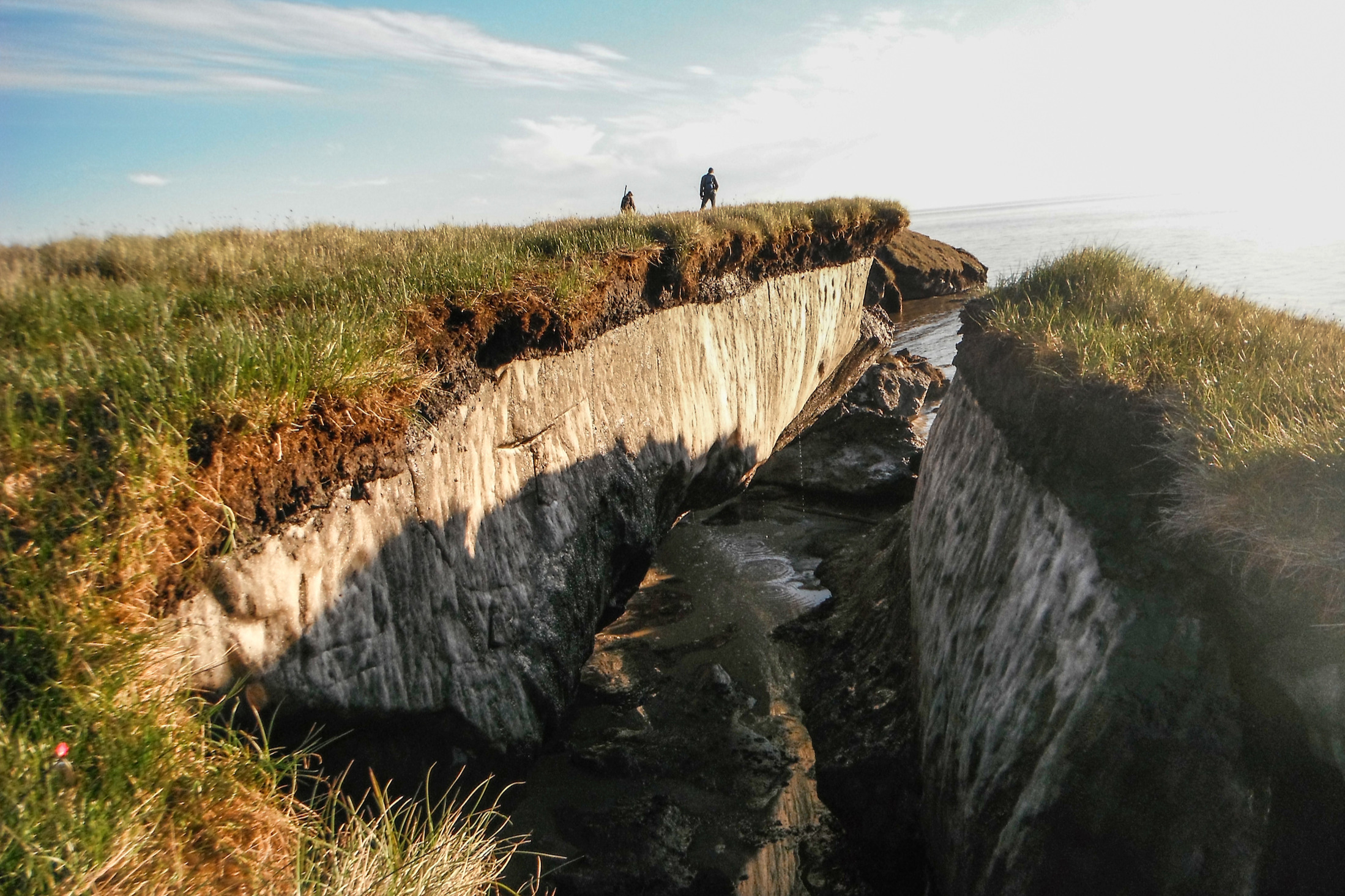 Coastal erosion reveals the extent of ice-rich permafrost underlying active layer on the Arctic Coastal Plain in the Teshekpuk Lake Special Area of the National Petroleum Reserve - Alaska. Credit: Brandt Meixell, USGS