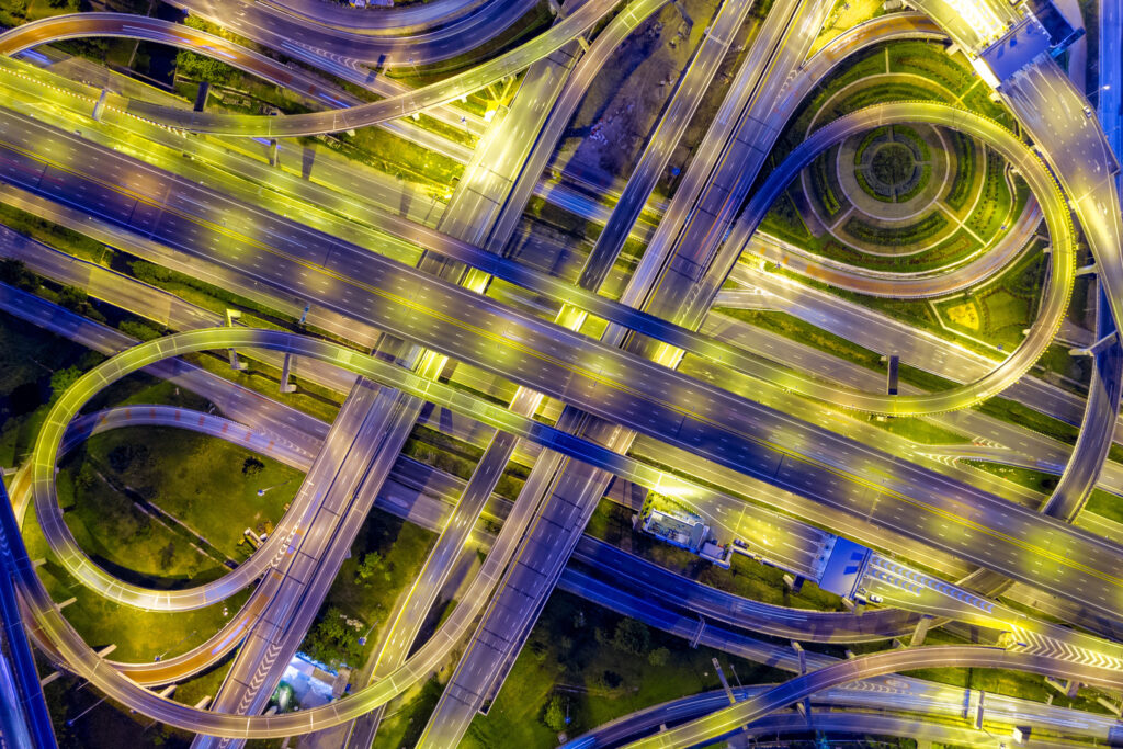 Top view of Highway road junctions at night. The Intersecting freeway road overpass the eastern outer ring road of Bangkok, Thailand.